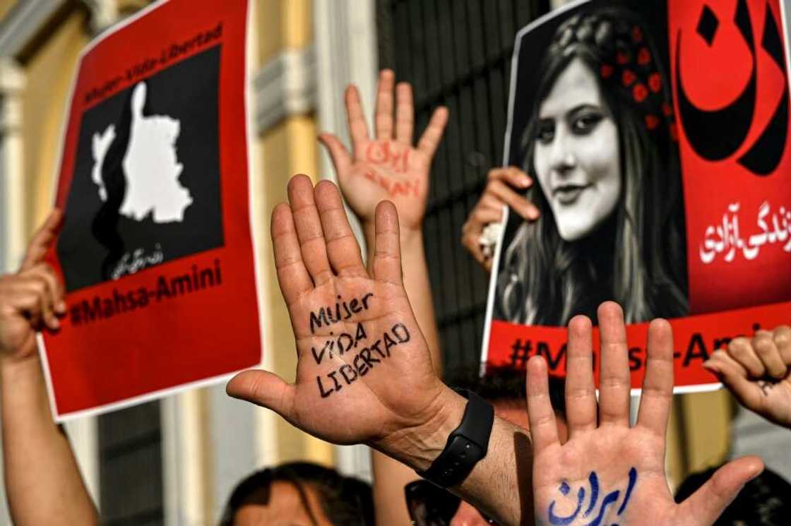 "Woman, life, freedom," demonstrators at a solidarity rally in the Chilean capital Santiago parade the catchcry of the Iran protests on the palms of their hands in Spanish and Persian "Woman, life, freedom," demonstrators at a solidarity rally in the Chilean capital Santiago parade the catchcry of the Iran protests on the palms of their hands in Spanish and Persian