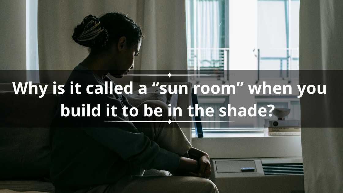 A woman in braided hair is sitting on her bed, seemingly in deep thought