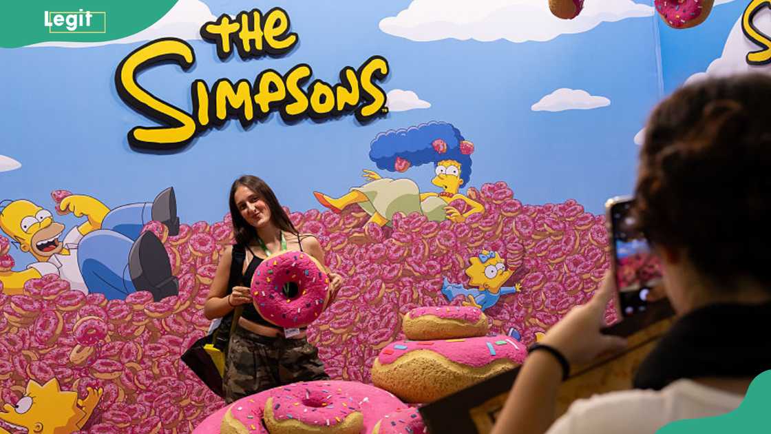 A colourful The Simpsons stand with giant pink doughnuts and the show's yellow logo at Comic-Con Málaga, Spain, 2026. A colourful The Simpsons stand with giant pink doughnuts and the show's yellow logo at Comic-Con Málaga, Spain, 2026.