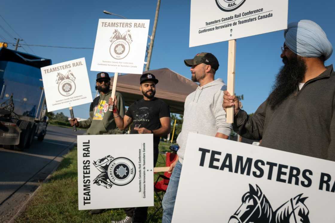 Locked out railway workers picket outside the CN Rail Brampton yard in Ontario province