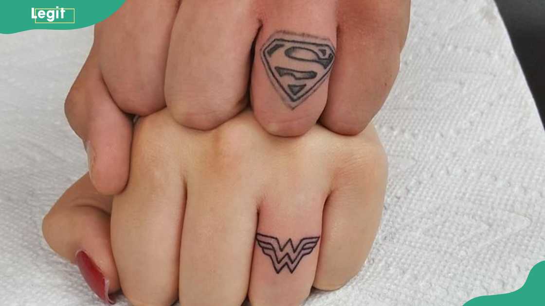 Superhero symbols ring tattoo