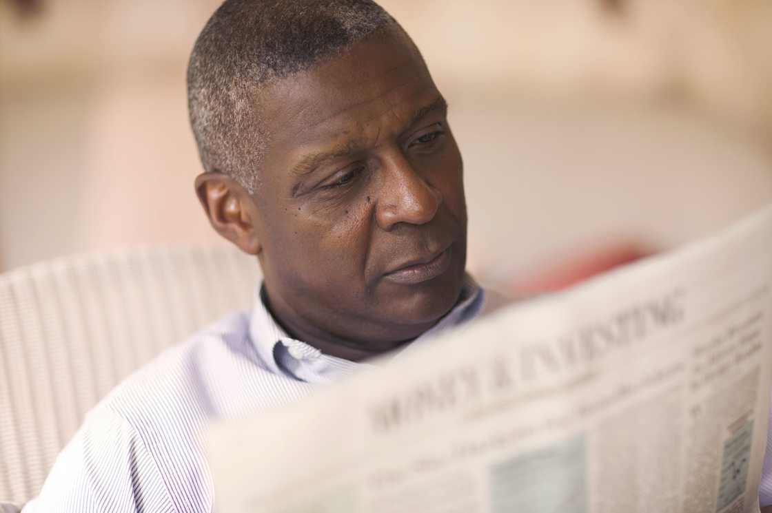 A senior man reading a newspaper A senior man reading a newspaper