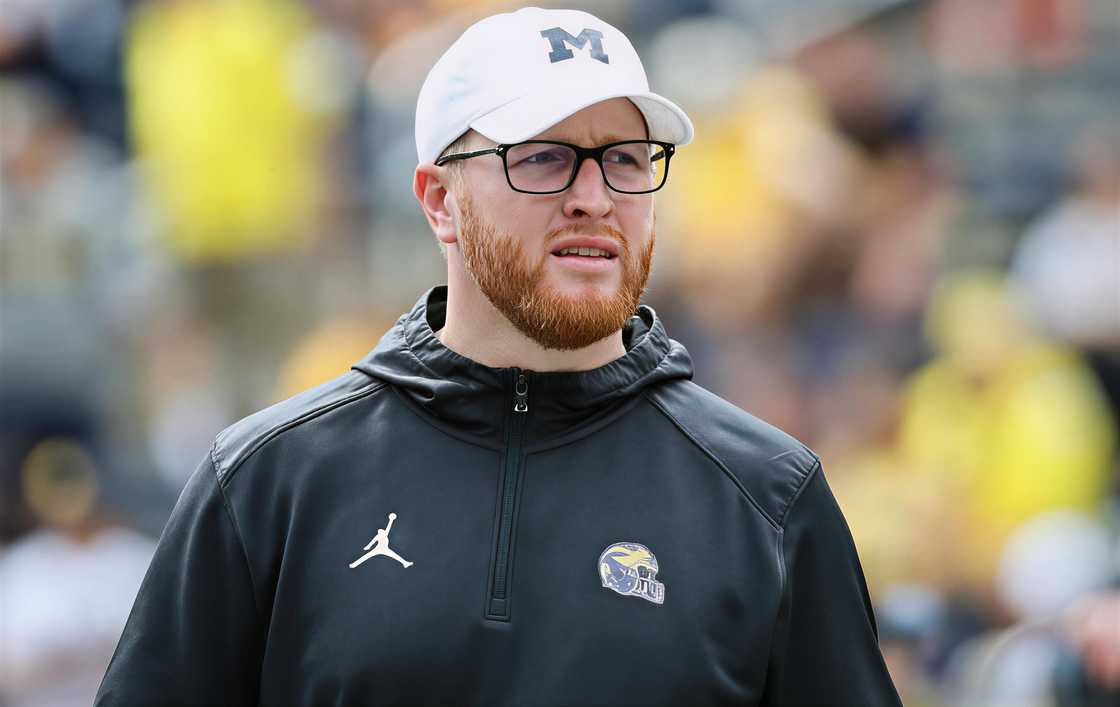 Jay Harbaugh looks on while on a football field Jay Harbaugh looks on while on a football field