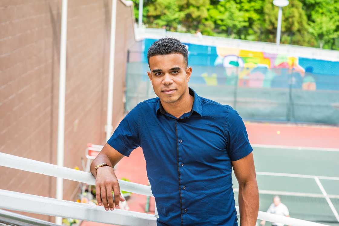 A man wearing blue short-sleeve shirt.