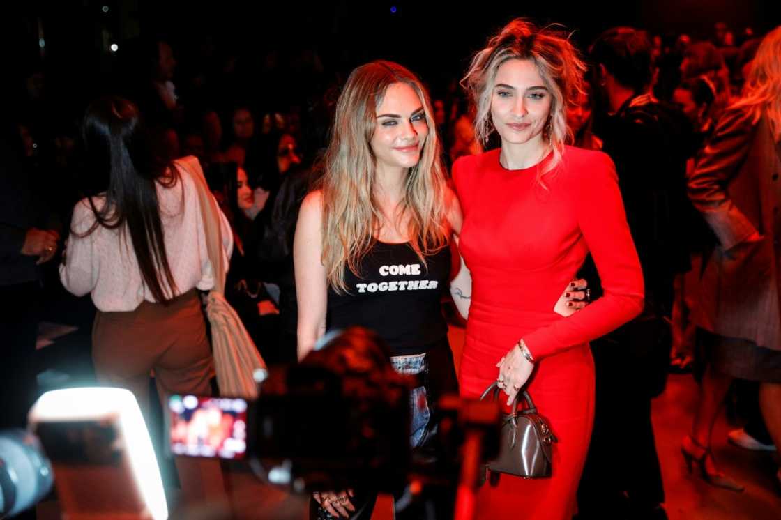 British model Cara Delevingne wore a "Come Together" t-shirt as she posed with singer and actress Paris Jackson at Stella McCartney's show British model Cara Delevingne wore a "Come Together" t-shirt as she posed with singer and actress Paris Jackson at Stella McCartney's show