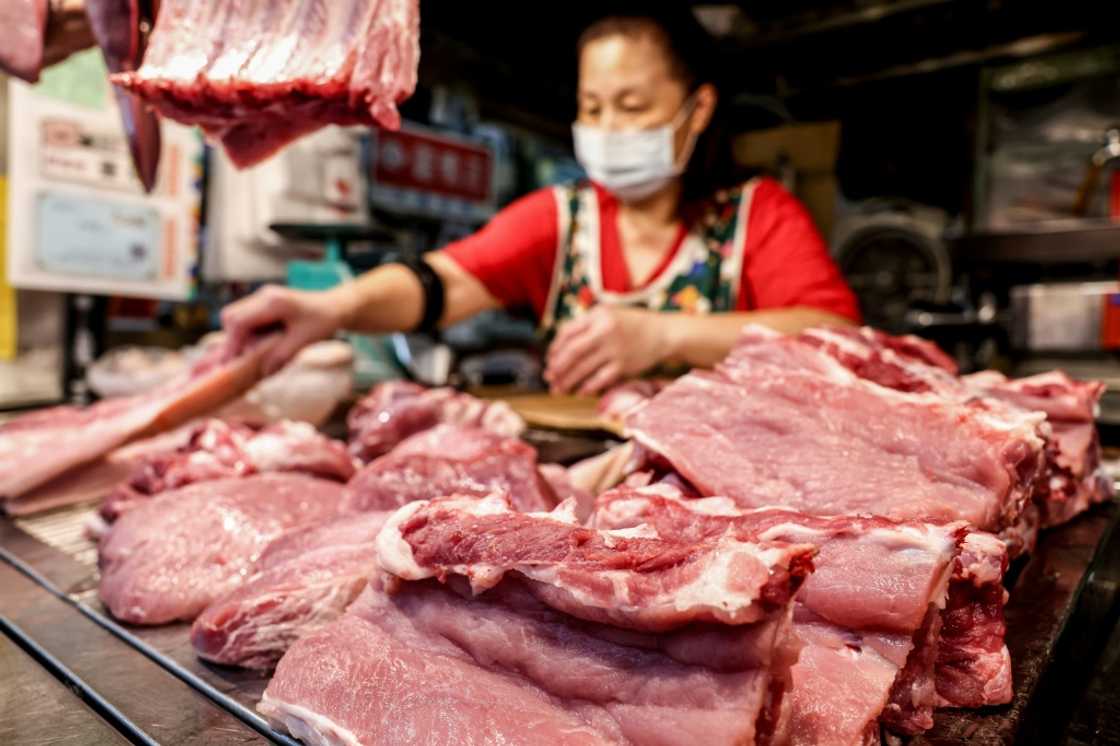 A vendor cuts meat at a pork stall at a local traditional market in Keelung. Taiwan has culled dozens of pigs after detecting its first cases of African swine fever A vendor cuts meat at a pork stall at a local traditional market in Keelung. Taiwan has culled dozens of pigs after detecting its first cases of African swine fever