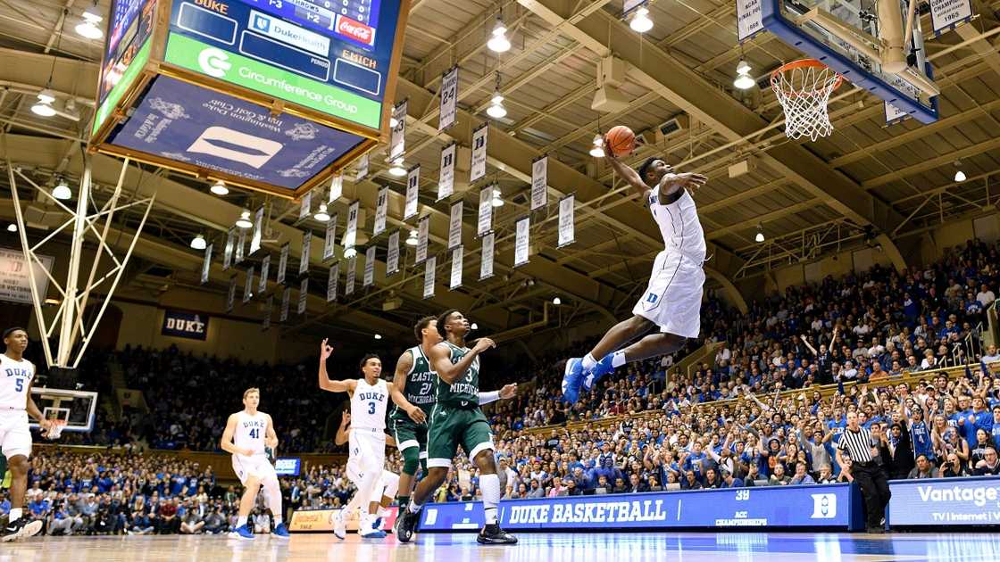 Zion Williamson of the Duke Blue Devils jumps high to dunk (White).