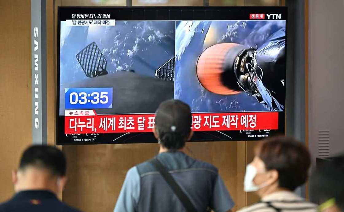 People in a railway station in Seoul watch a television screen showing a SpaceX Falcon 9 rocket launching with South Korea's first lunar orbiter Danuri onboard from Cape Canaveral in Florida People in a railway station in Seoul watch a television screen showing a SpaceX Falcon 9 rocket launching with South Korea's first lunar orbiter Danuri onboard from Cape Canaveral in Florida