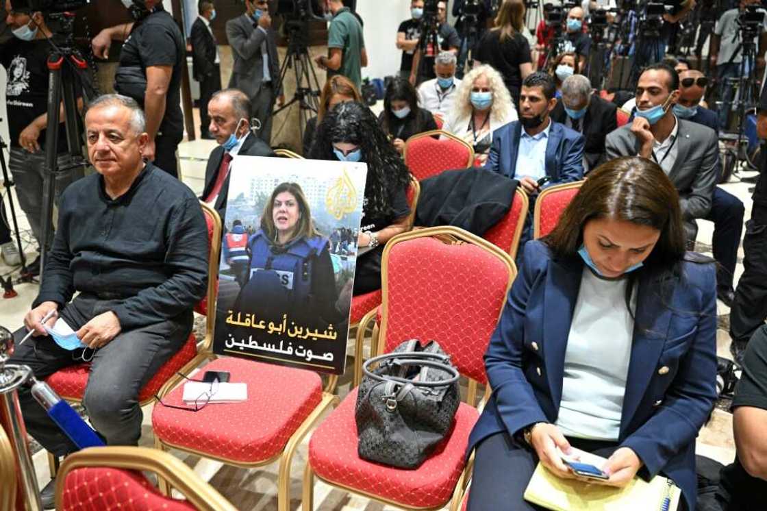 A photo of slain US-Palestinian Al Jazeera correspondent Shireen Abu Akleh, with a caption in Arabic calling her "the voice of Palestine", is seen amongst reporters ahead of a joint press conference between the US and Palestinian presidents A photo of slain US-Palestinian Al Jazeera correspondent Shireen Abu Akleh, with a caption in Arabic calling her "the voice of Palestine", is seen amongst reporters ahead of a joint press conference between the US and Palestinian presidents