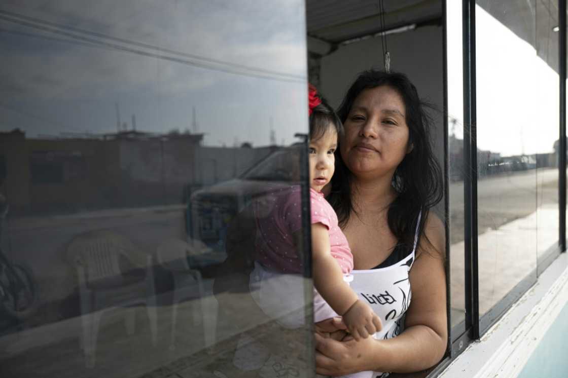 Sayuri Moreno, 37, and her daughter Valeria pose for a picture at their home in Huarmey