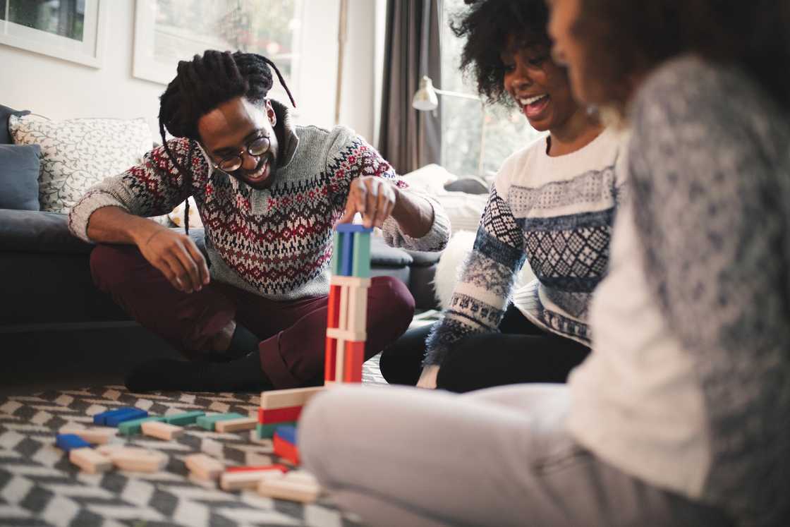 A group of friends playing a block game