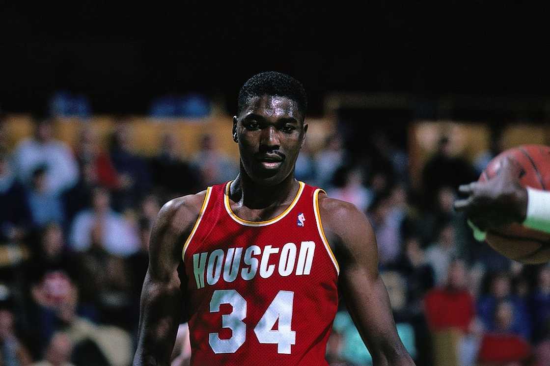 Hakeem Olajuwon looks on against the Boston Celtics during a game Hakeem Olajuwon looks on against the Boston Celtics during a game