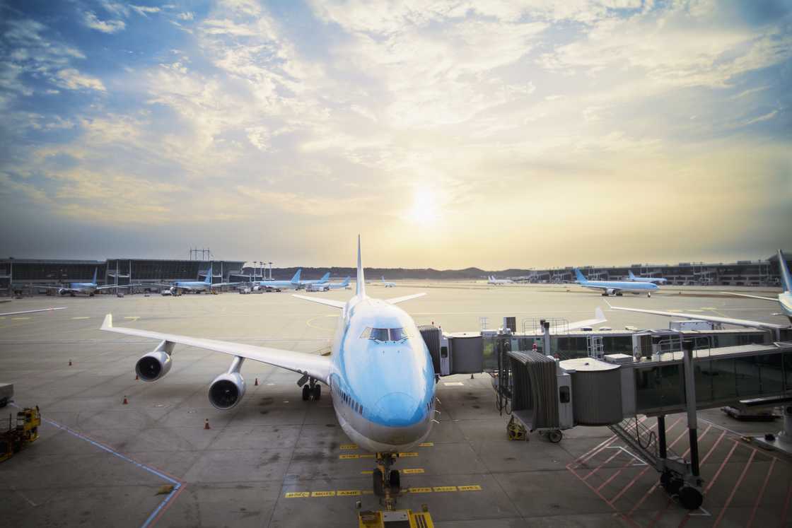 Airplane parked at gate at sunset at Seoul Incheon International Airport, South Korea Airplane parked at gate at sunset at Seoul Incheon International Airport, South Korea
