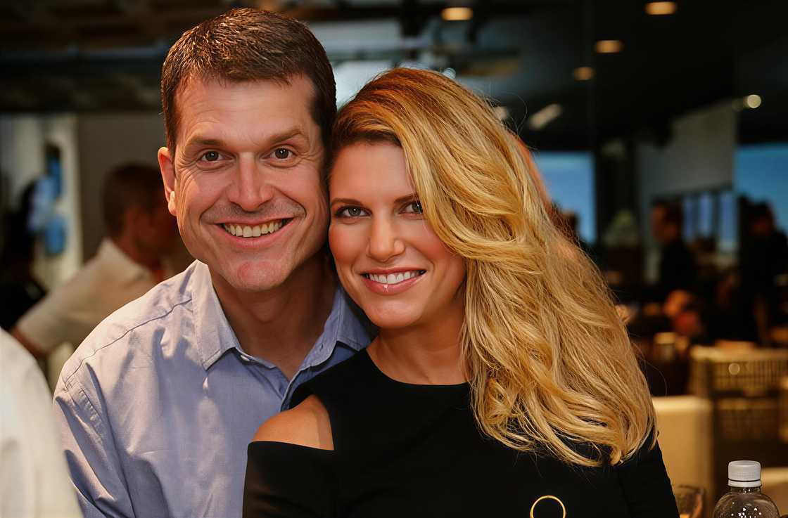 Jim Harbaugh holds his wife, Sarah Feuerborn Harbaugh, during a pose for a photo at an event. Jim Harbaugh holds his wife, Sarah Feuerborn Harbaugh, during a pose for a photo at an event.