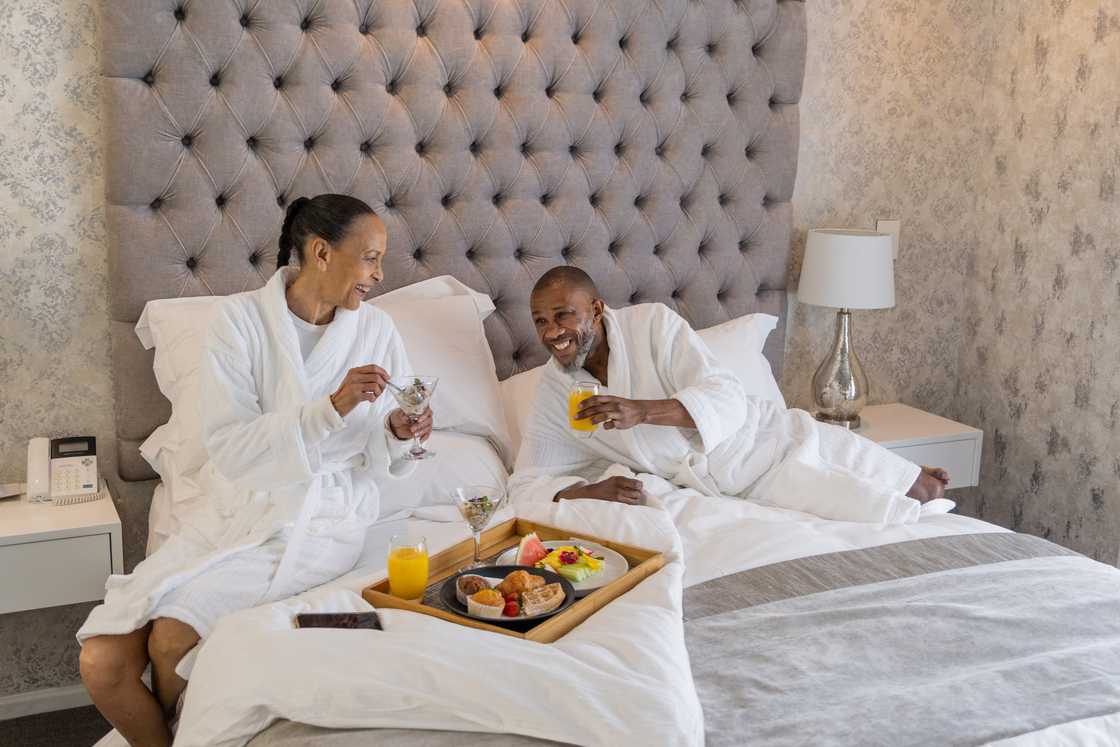 A couple having breakfast in bed. A couple having breakfast in bed.