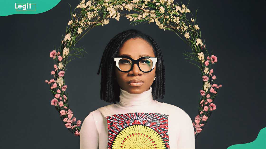 Asa Bukola in a dark background with circular flowers