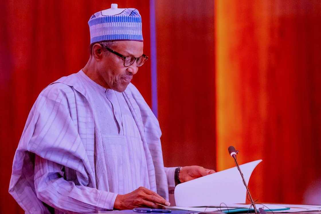 Shugaban kasa Buhari a tsaye da takarda a hannunsa Shugaban kasa Buhari a tsaye da takarda a hannunsa