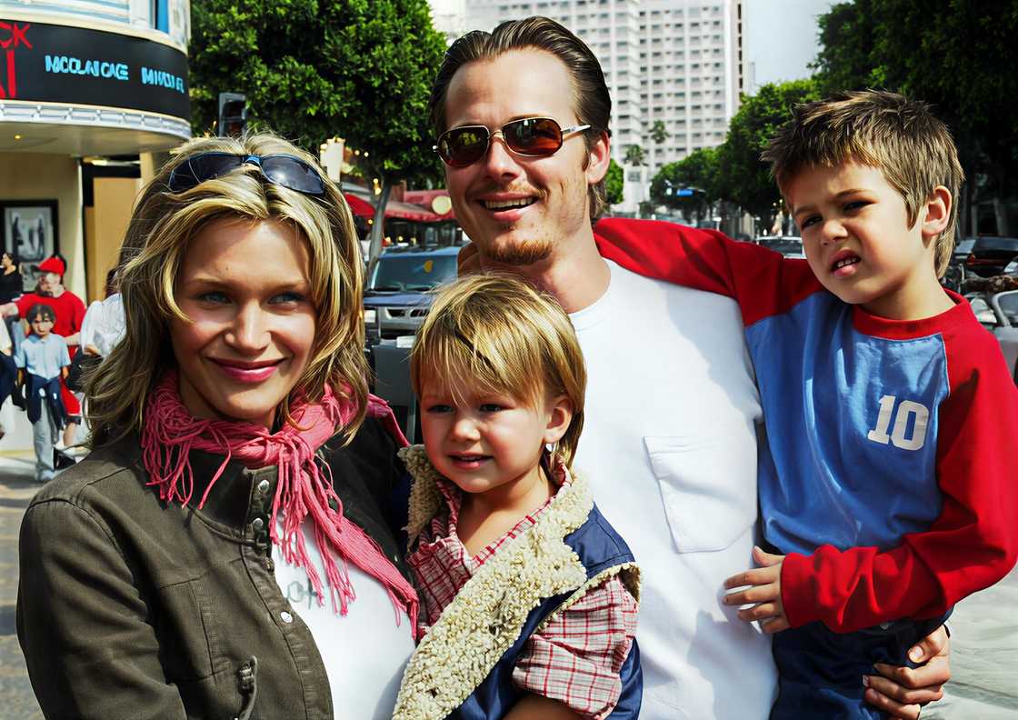 Natasha Henstridge and Liam Waite carry their children