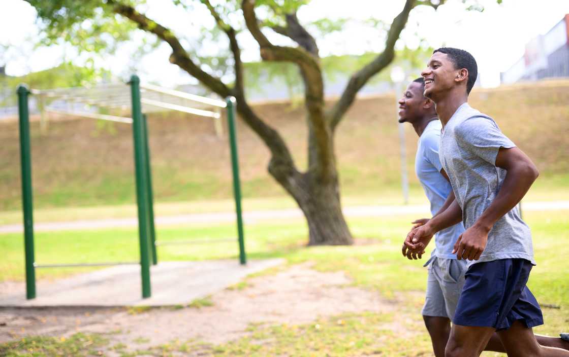 Two athletes run on a track. Two athletes run on a track.