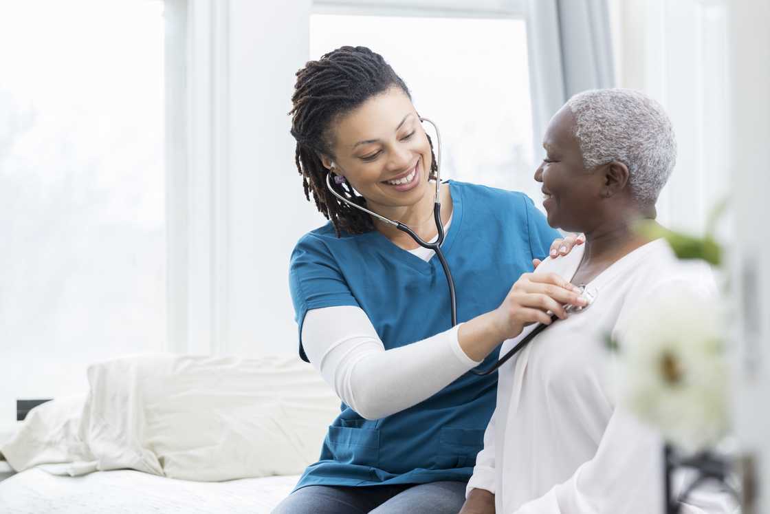 A healthcare worker examining a patient