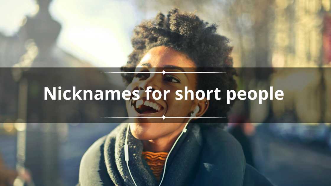 A happy woman with afro hair is pictured walking down a street