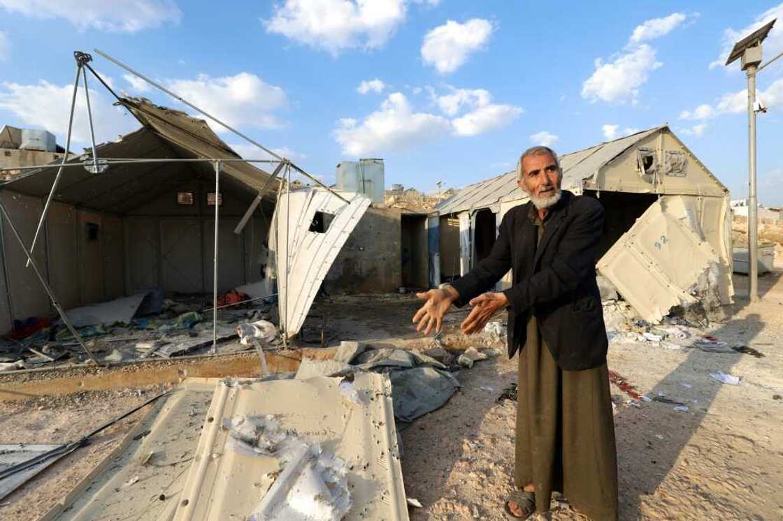 A man shows damage caused by the deadly rocket strikes A man shows damage caused by the deadly rocket strikes