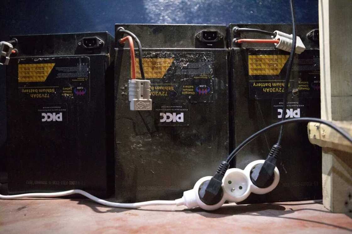 Rechargeable batteries used by electric motorcycle drivers are charged in a store in Cotonou Rechargeable batteries used by electric motorcycle drivers are charged in a store in Cotonou