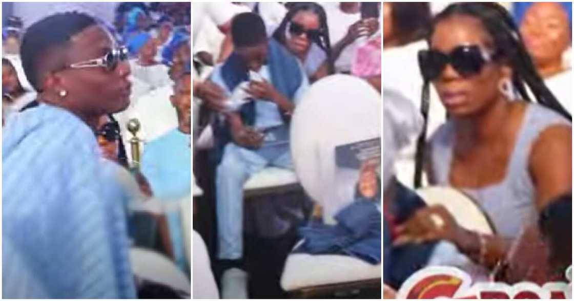 Wizkid stand up to console his son Bolu at his mum's burial. Wizkid stand up to console his son Bolu at his mum's burial.