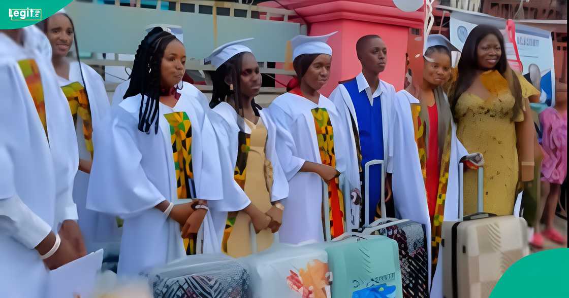 A Nigerian mother reacts to the gifts graduating students collected at her daughter’s school’s graduation party.