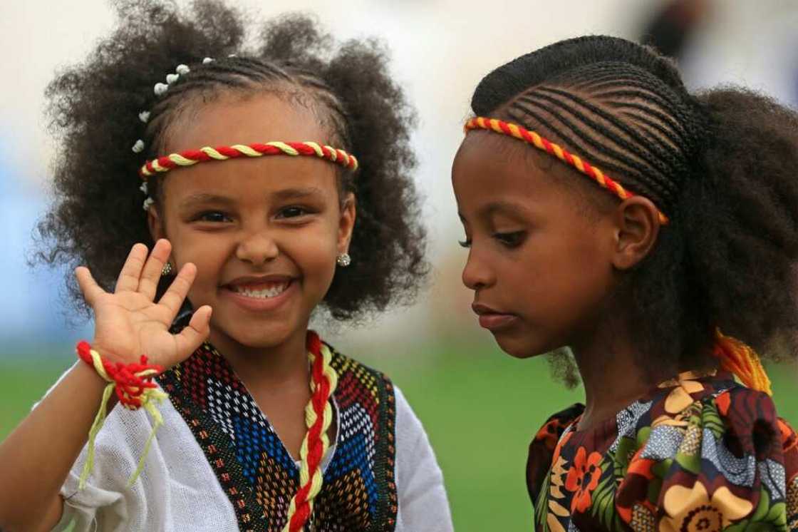 Ethiopian girls, wearing headbands in the colours of the Tigrayan flag, take part in the Ashenda celebrations at al-Qurashi park in the Sudanese capital Khartoum Ethiopian girls, wearing headbands in the colours of the Tigrayan flag, take part in the Ashenda celebrations at al-Qurashi park in the Sudanese capital Khartoum