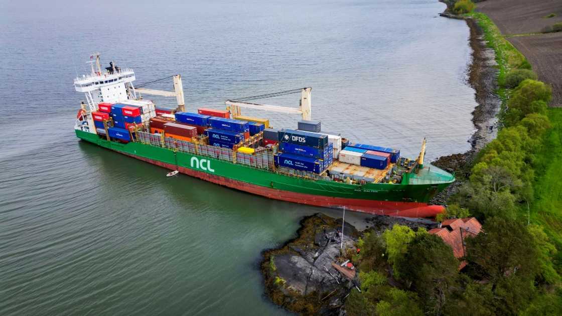 A cargo ship has been freed after running aground near a house in Norway
