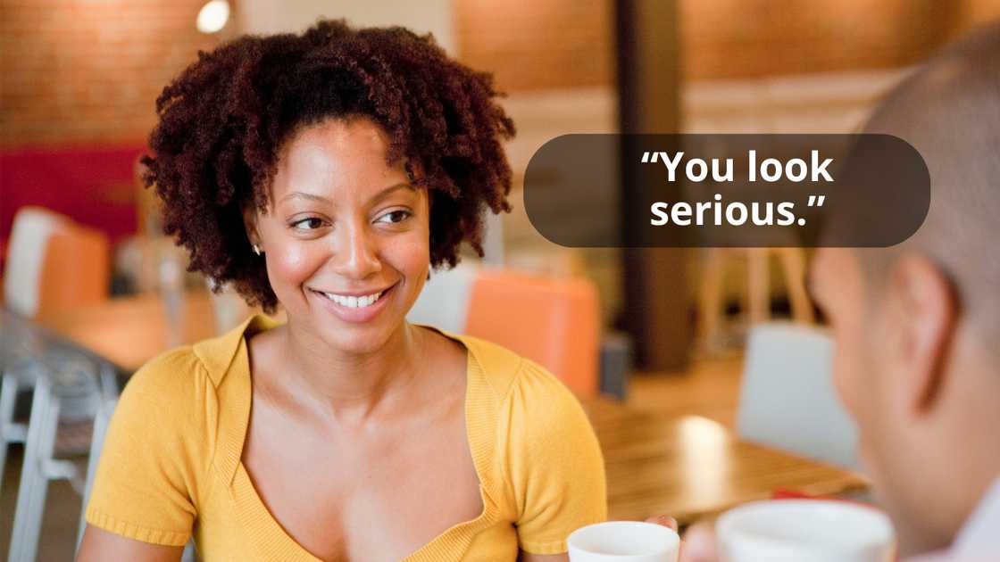 A beautiful woman talking to a man while smiling