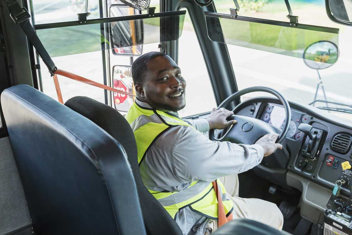 A bus driver smiles