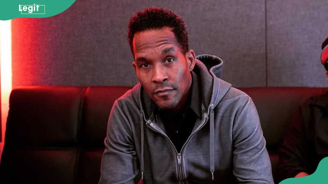 Rapper Sivion looks on as he sits on a couch Rapper Sivion looks on as he sits on a couch