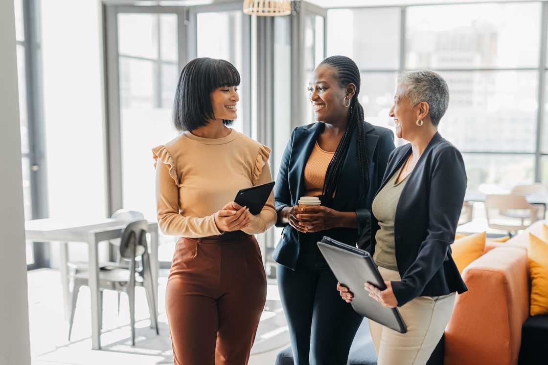 Businesswomen in meeting conversation at digital marketing agency company.