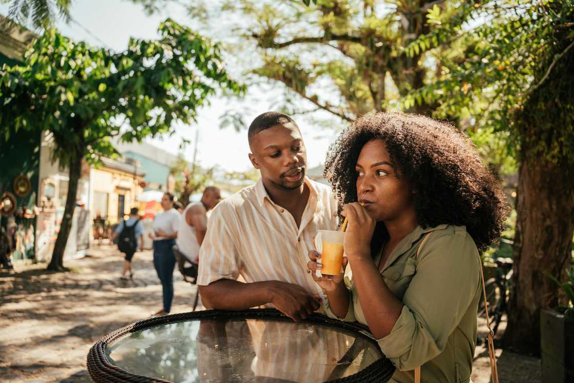A woman sitting with a friend outdoors.