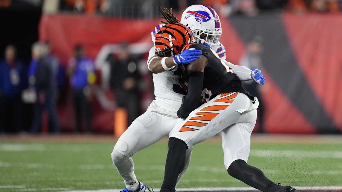 Damar Hamlin (back) was hit by Tee Higgins (front) during a football game.