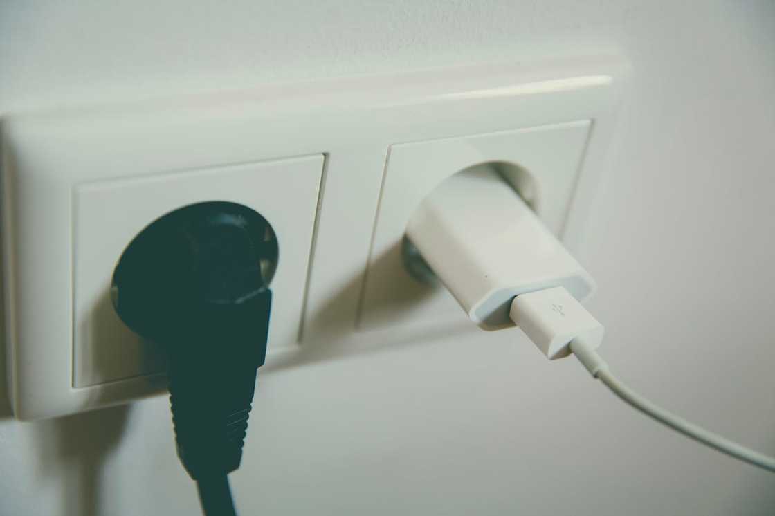 A phone charger plugged into a wall socket.