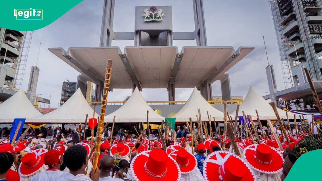 President Bola Tinubu and Lagos Governor Babajide Sanwo-Olu attending the Eyo Festival, surrounded by participants in traditional white robes and hats. President Bola Tinubu and Lagos Governor Babajide Sanwo-Olu attending the Eyo Festival, surrounded by participants in traditional white robes and hats.