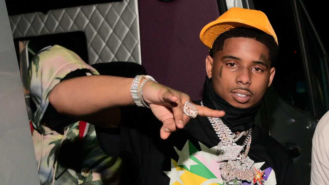 Rapper Pooh Shiesty gestures as he poses for a photo during the 2021 Onyx Monday Nights party at Onyx Nightclub