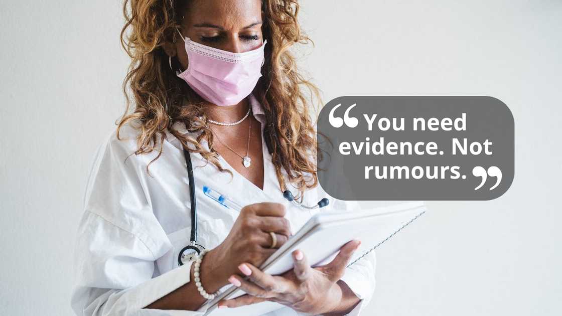 A nurse wearing a mask writes notes on a medical clipboard. A nurse wearing a mask writes notes on a medical clipboard.