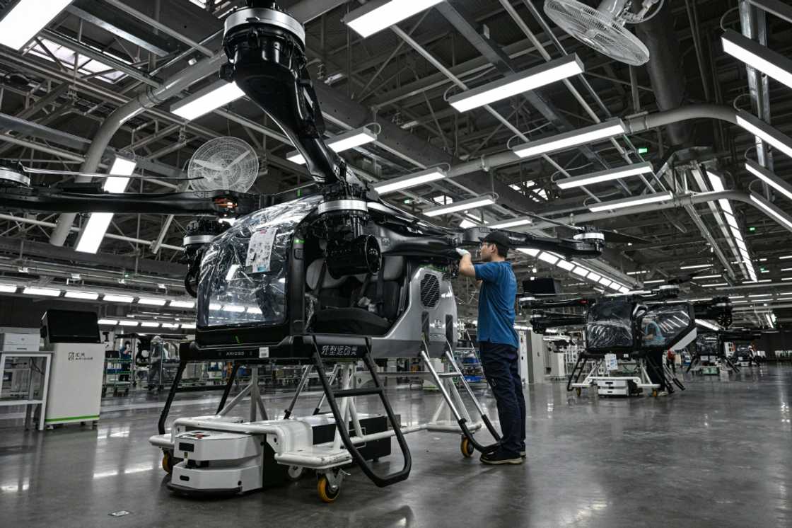 Employees work on the assembly line for the electric flying car at a factory of Xpeng's subsidiary Aridge