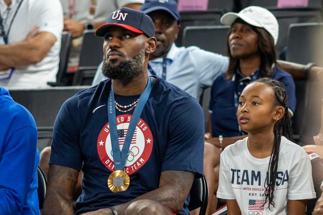 LeBron James, wearing his gold medal with daughter Zhuri Nova