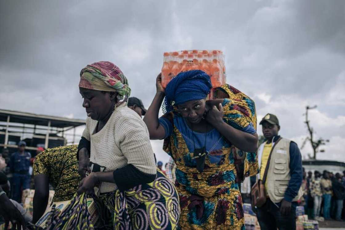 People who fled the advancing M23 receive a handout of biscuits and soda at an informal camp in northern Goma People who fled the advancing M23 receive a handout of biscuits and soda at an informal camp in northern Goma