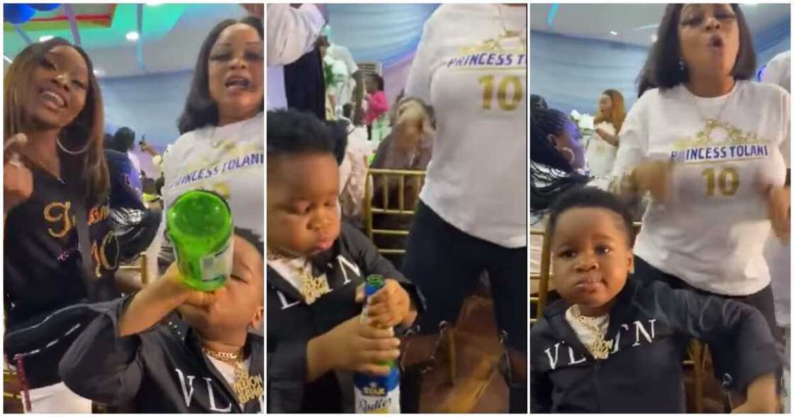 Nigerians react to video of little boy drinking beer at event and dancing with women Nigerians react to video of little boy drinking beer at event and dancing with women
