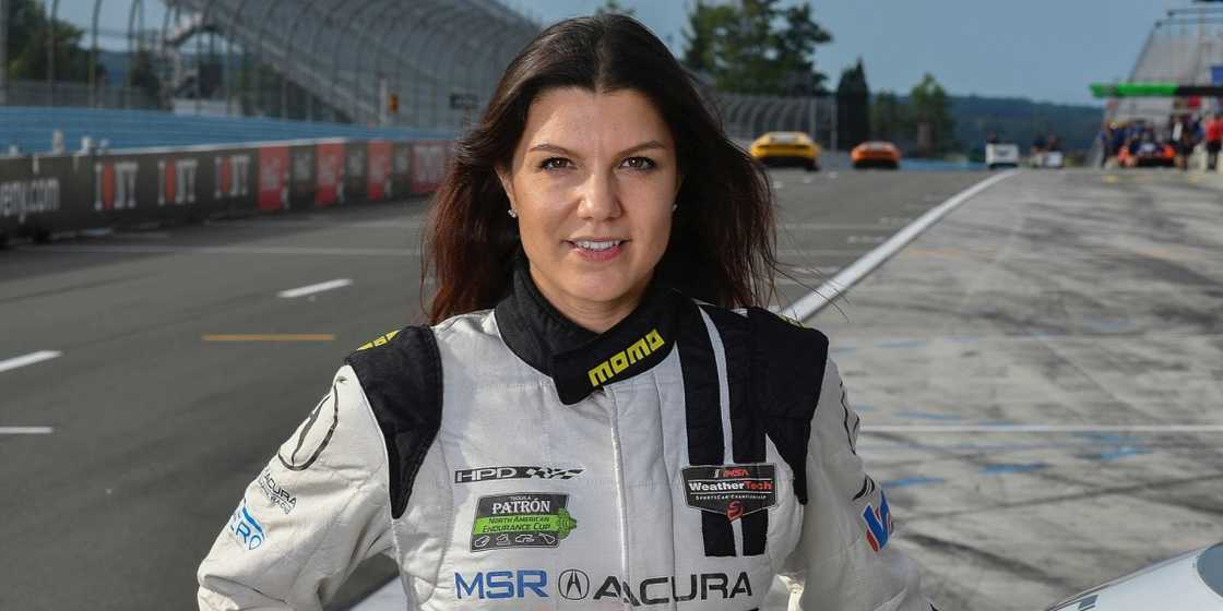 Katherine Legge poses on a racetrack. Katherine Legge poses on a racetrack.