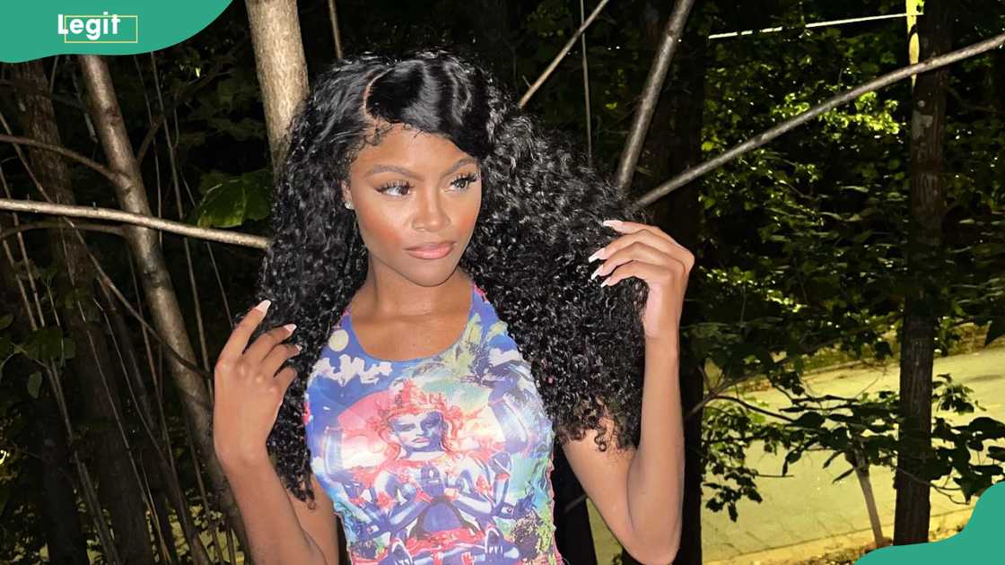 Destiny Davis at a garden-like area with trees, branches, and dense greenery Destiny Davis at a garden-like area with trees, branches, and dense greenery