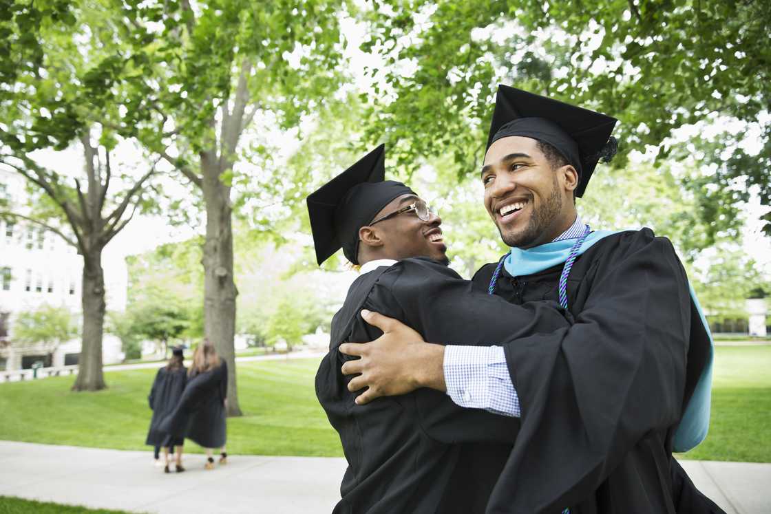 Graduates hugging and smiling