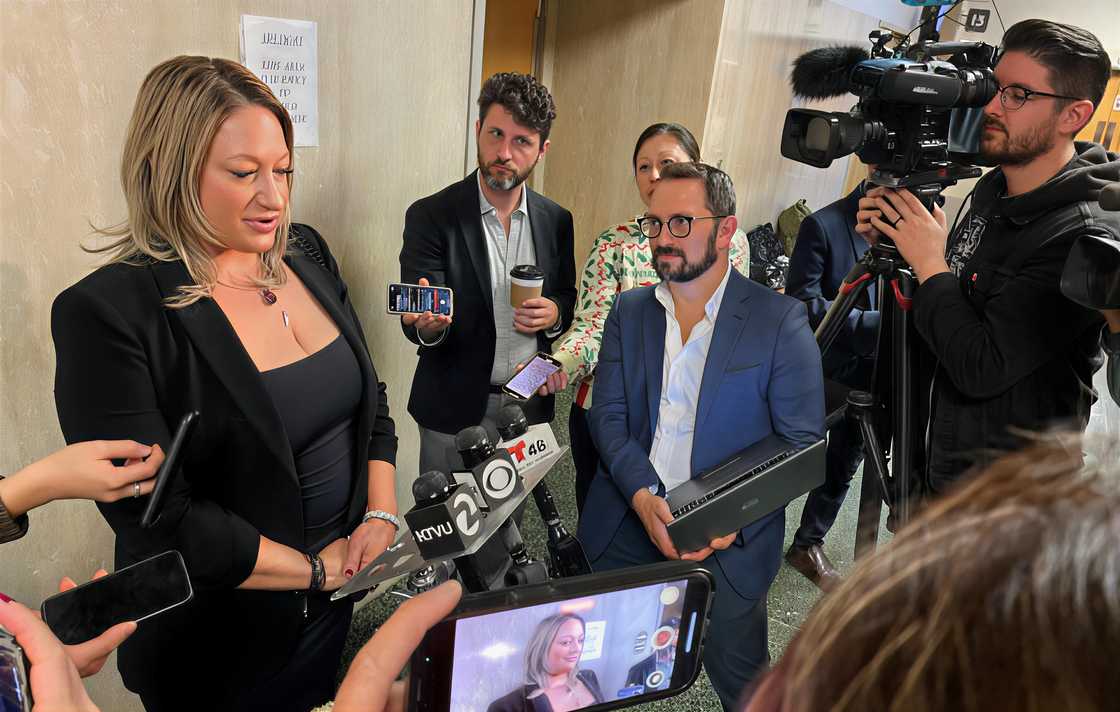 Krista Lee, speaks to reporters