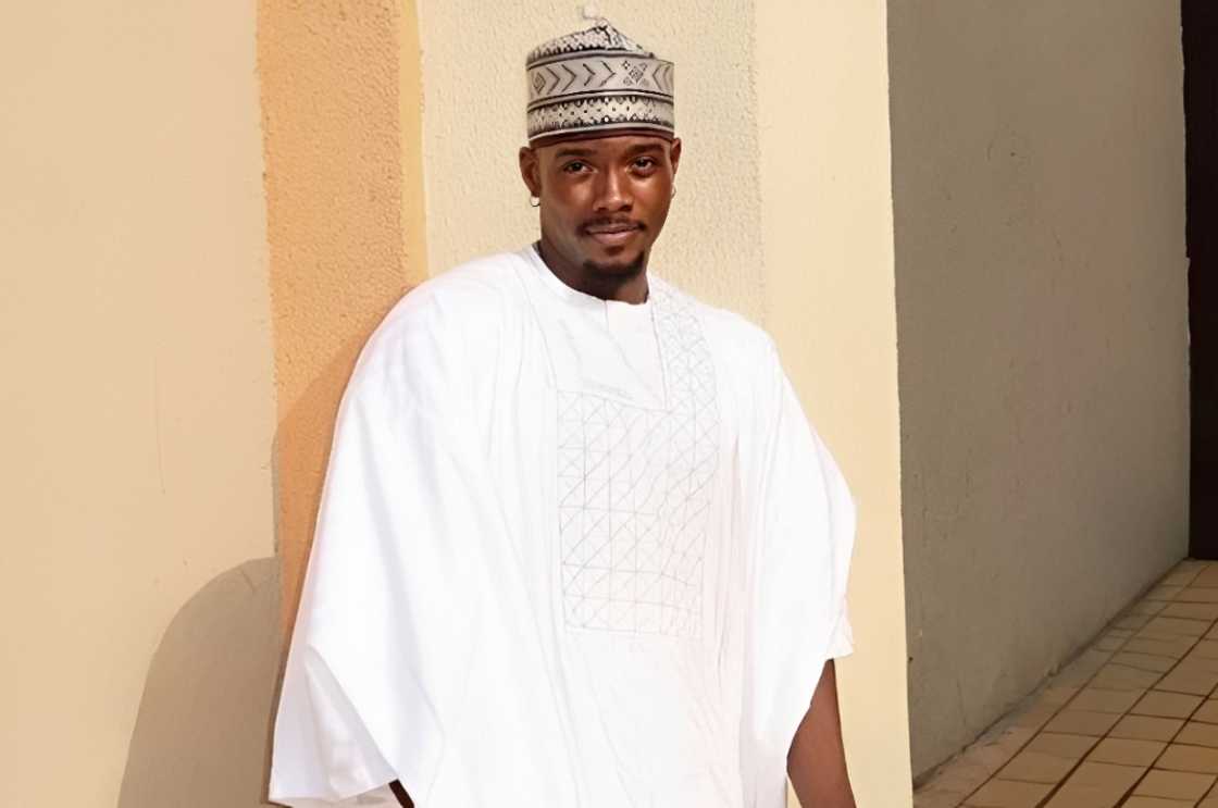 Yusuf Muhammad-Awal, poses in a white agbada.